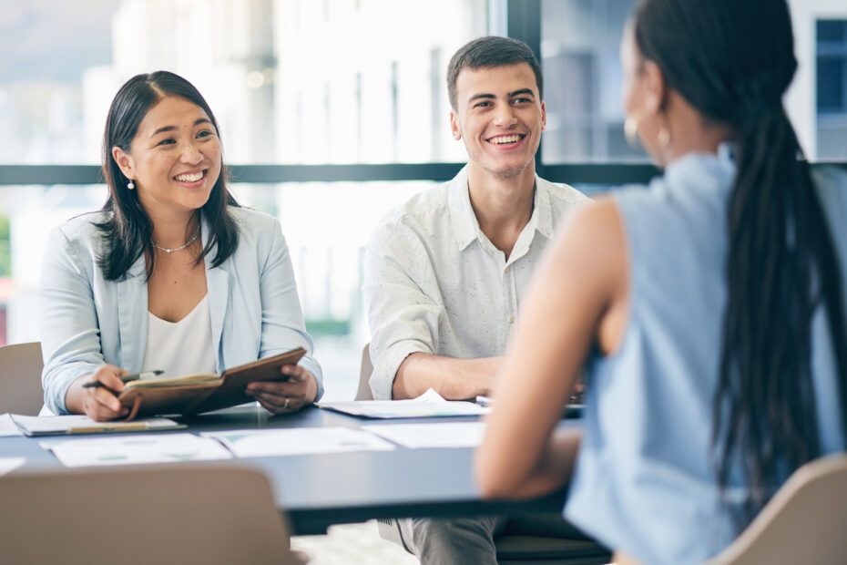 Job candidates in an interview with a businesswoman.